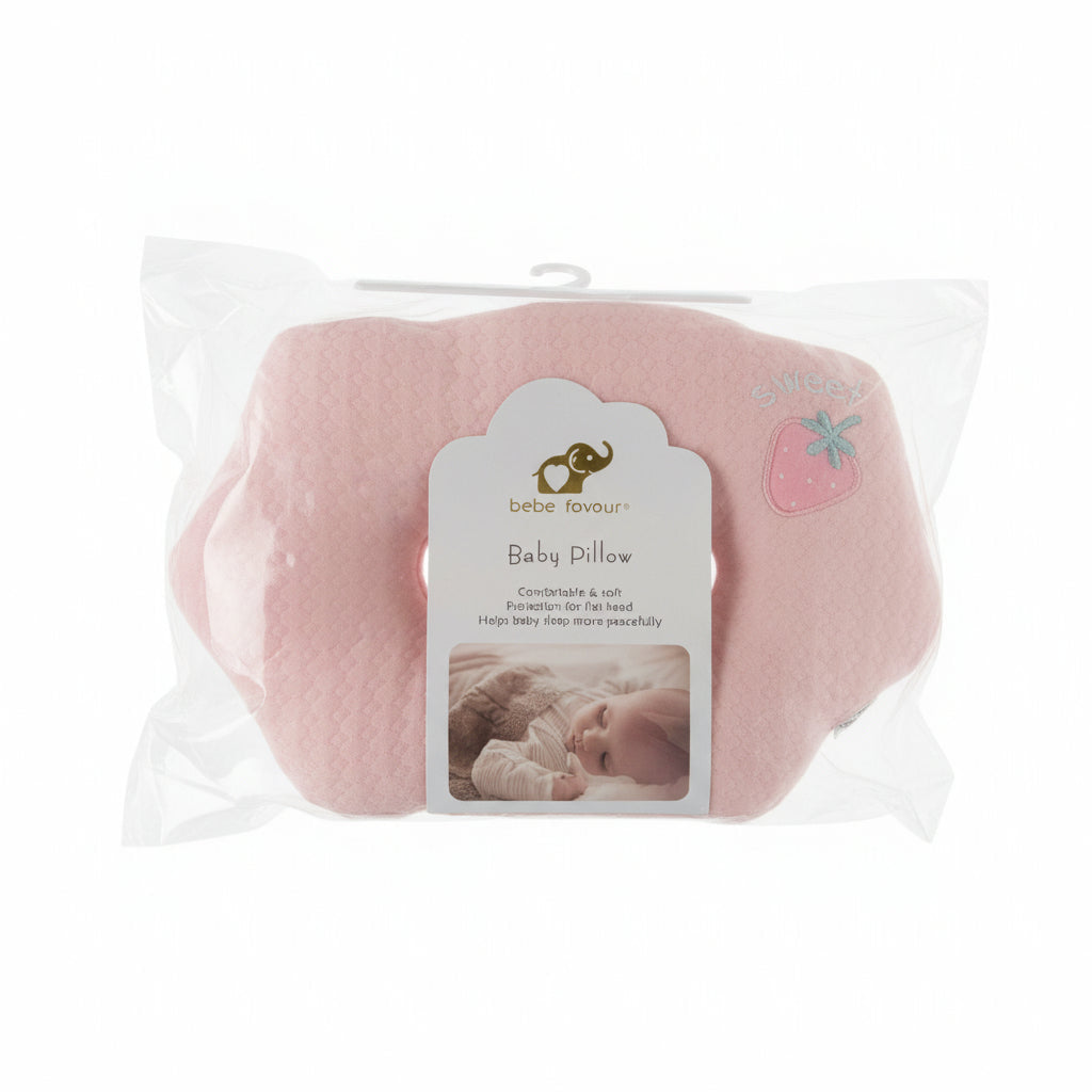 A pink baby pillow in clear plastic packaging with a white and gray label that reads 'Baby Pillow' and 'Super Gentle.' The pillow has a small embroidered strawberry motif near the bottom right.