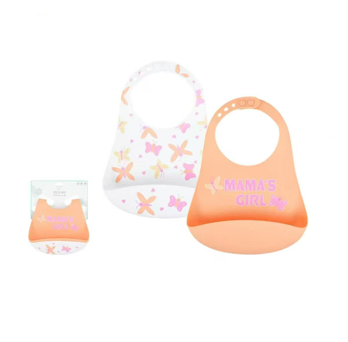 Two silicone baby bibs on a white background with product text and a small packaged view. One bib is white with pastel butterfly and heart prints, and the other is peach-orange with pink 'MAMA'S GIRL' text.