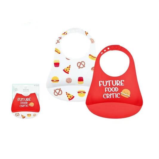 Two silicone baby bibs on a white background with product text and a small package inset. One bib is white with colorful food illustrations, and the other is bright red with the words 'FUTURE FOOD CRITIC' and a burger graphic.
