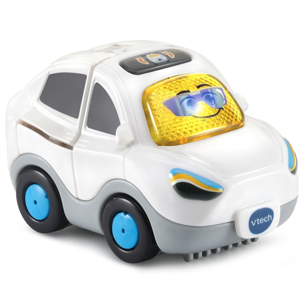 A VTech toy car with a white body, gray lower trim, blue wheels, and a yellow textured windshield with a smiling face.