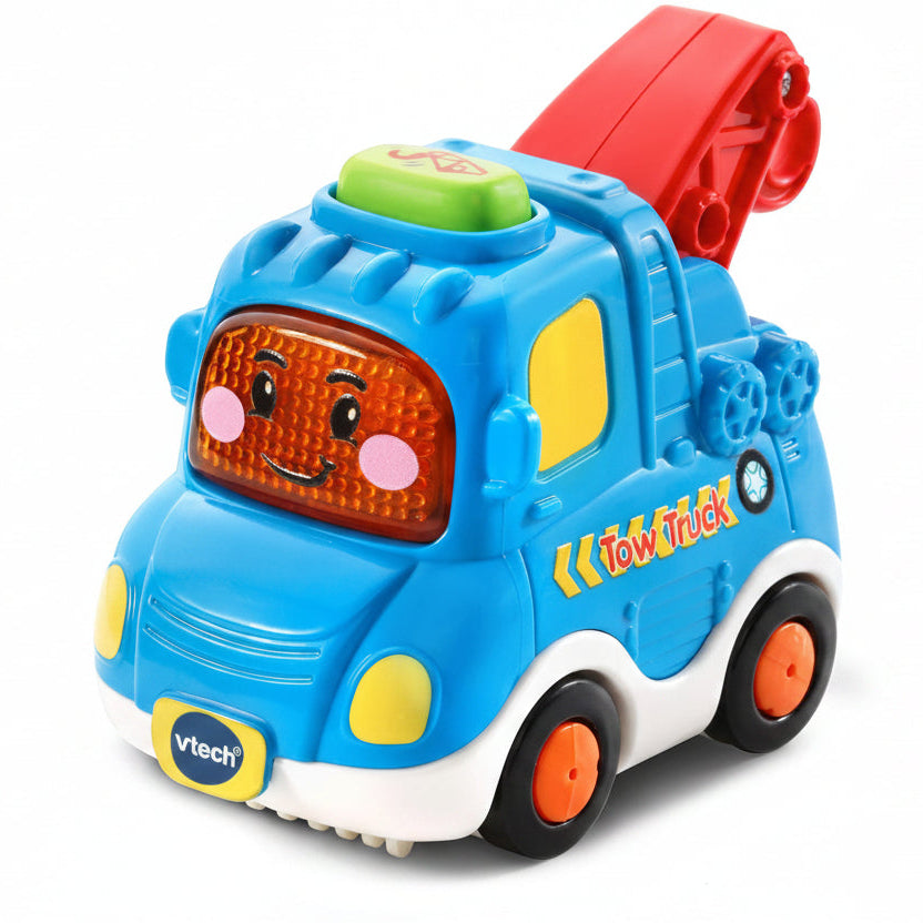 Vtech Tow Truck toy in bright blue with a red crane, yellow details, and a smiling face on the front, shown on a white background.